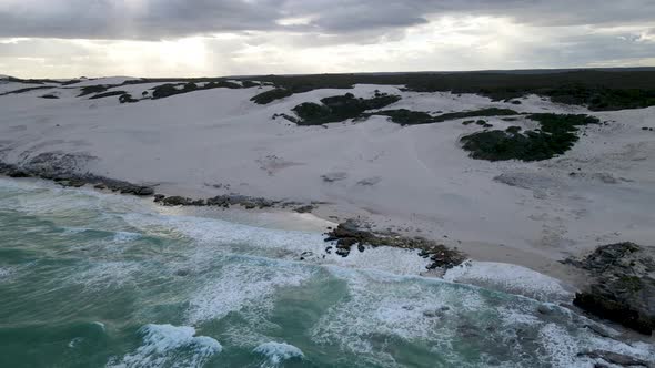 Aerial view of remote beach with man walking, Western Cape, South Africa.