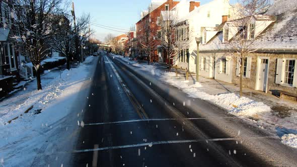 AERIAL Dolly Back Down Main Street, Snowing Historic Country Town