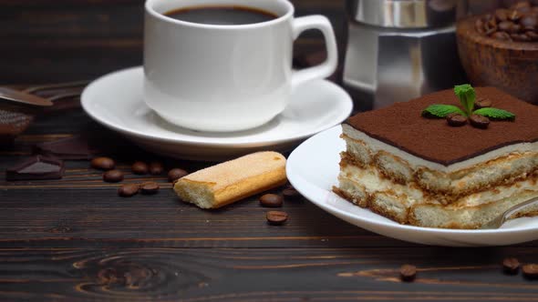 Portion of Traditional Italian Tiramisu Dessert Cup of Espresso Mocha and Coffee Beans