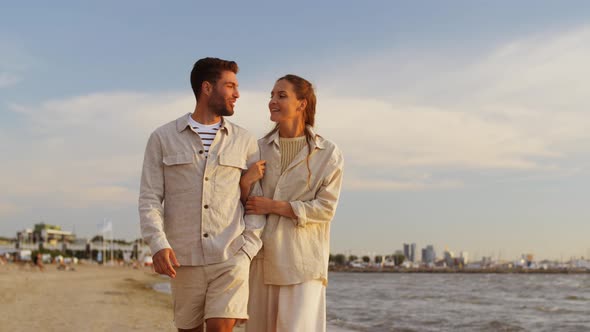 Happy Couple Walking Along Summer Beach