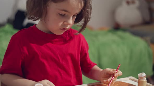 Caucasian Girl Girl Draws with a Brush on Paper