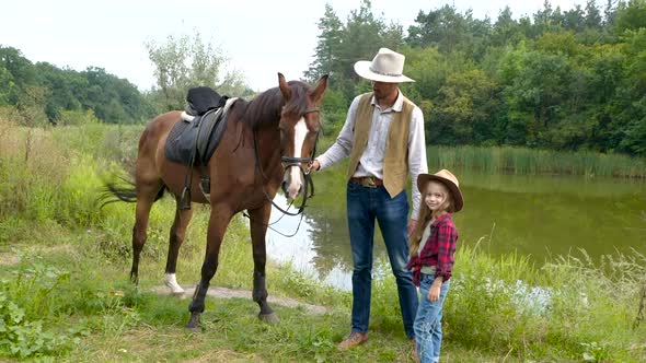 Cowboy and His Daughter with Their Horse