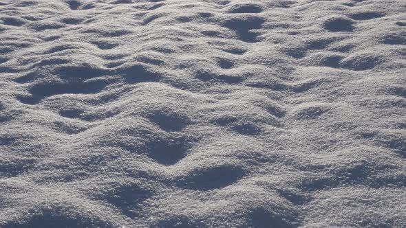 Tilting on crystals of shiny snow 4K 2160p 30fps UltraHD footage - Shallow DOF clear white frozen cr