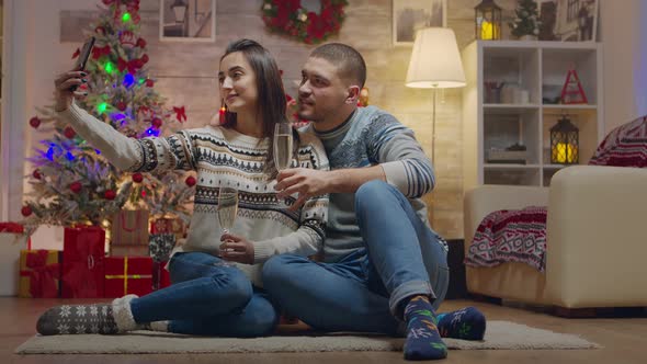 Lovely Couple on Christmas Day Drinking Champagne