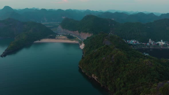 Aerial: flying over Cat Ba island at dusk, Ha Long Bay famous tourism destination in Vietnam