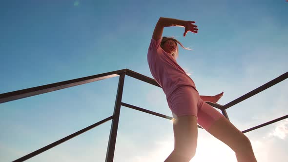 Flexible Woman Artist Performing Outdoor Street Dancing in Stairs at Sky