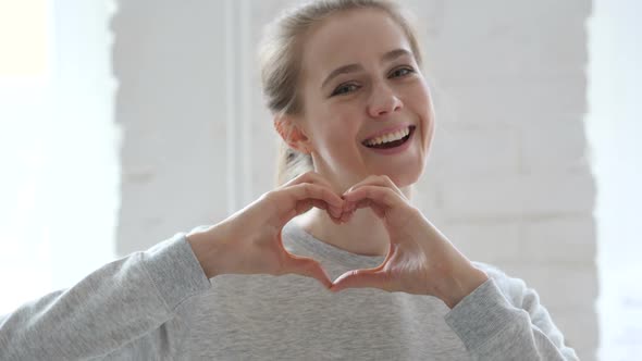 Heart Sign By Young Woman in Love Hands Gesture