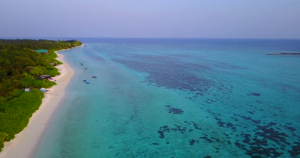 Tropical aerial abstract shot of a sunshine white sandy paradise beach and aqua blue water backgroun