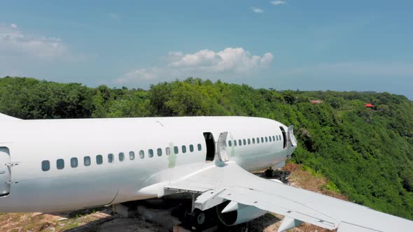 Flight Above an Airplane Standing on Edge of a Cliff in a Green Tropical Paradise