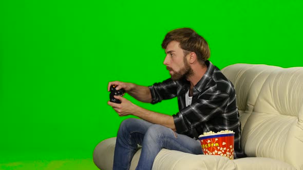 Man Desperately Fighting in the Game on the Console. Green Screen