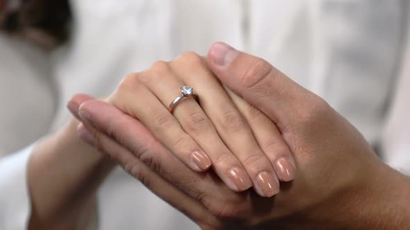 Loving Man Holding Girlfriends Hand With Engagement Ring on Finger, Marriage