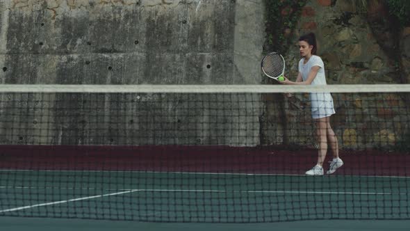 Woman playing tennis on a court