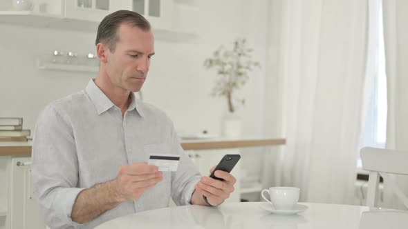 Middle Aged Man Making Successful Payment on Smartphone
