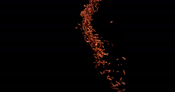 Cayenne Chili Pepper, capsicum frutescens, spice falling against Black Background, Slow Motion 4K