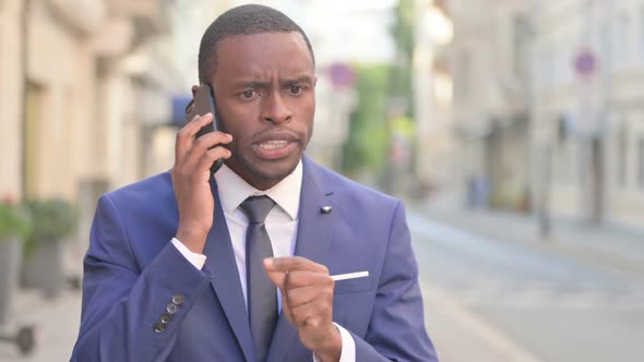 Outdoor African Businessman Getting Angry on Call in Street