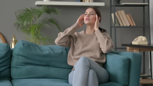 Woman Having Headache While Sitting on Sofa