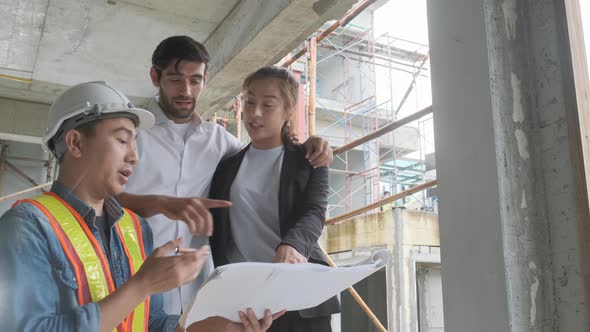 Couple checks the work of a contractor building a house for them.