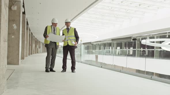 Men Talking in Mall Under Construction