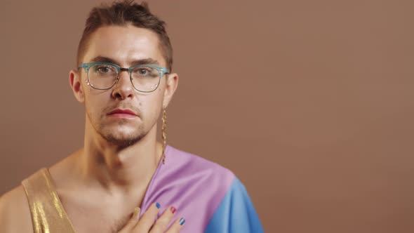 Gay Man with Rainbow Flag on Shoulder Posing for Camera