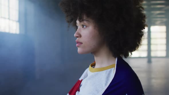 Portrait of african american woman with american flag on her back in empty parking garage