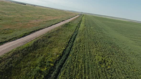 Top view of rural road near agricultural fields