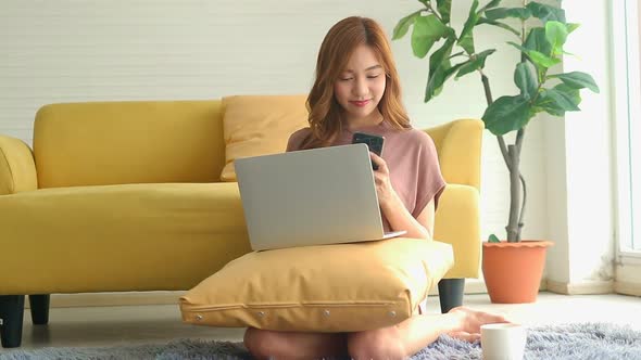 beautiful asian woman Sitting at home working in the living room.