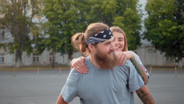 Beauty Woman Jumping on Loving Boyfriend Back Happy Man Riding Her in Green Summer Park Romantic