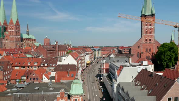 Forwards Fly Above Street in Historic Town