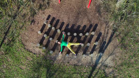 Aerial view of man laying down over wooden stumps, Zagreb, Croatia.