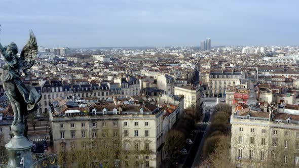Angel of liberty Girondins column in Bordeaux, France with city panoramic, Aerial dolly left reveal