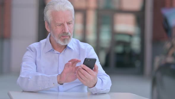 Outdoor Old Man Using Smartphone