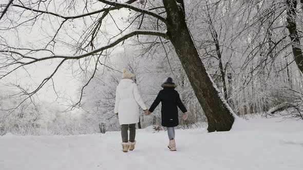 Mom and Daughter Walking in Nature in Winter