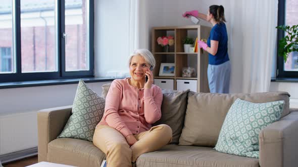 Happy Senior Woman Calling on Smartphone at Home