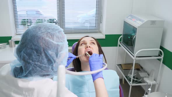 Young Woman on Preventive Examination in Dental Chair at the Dentist