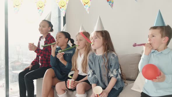 Group of Children Celebrating Birthday Party at Decorated Home