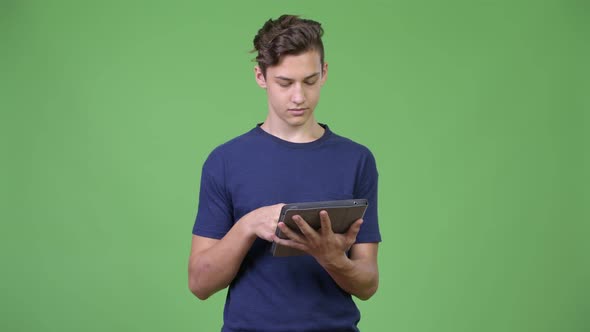 Young Handsome Teenage Boy Using Digital Tablet