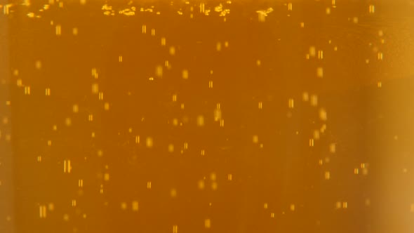 Tilting on glass full of beer and bubbles flowing up 4k 2160p UltraHD footage - Bubbles and foam in 