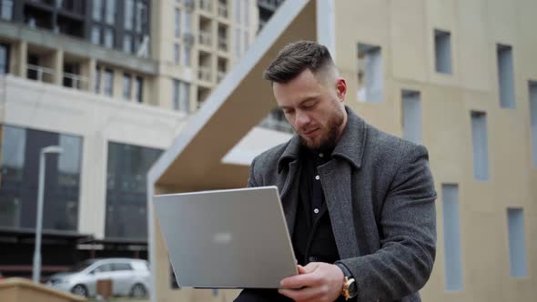 Young man with a laptop on fresh air. 