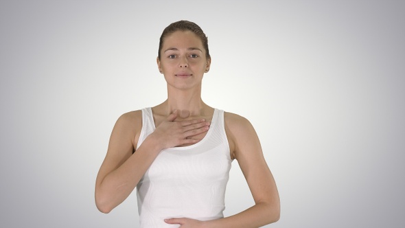 Happy woman breathing deeply doing exercise on gradient background