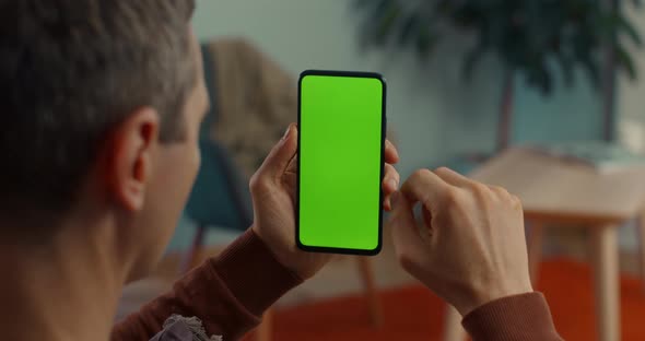 Caucasian Man Doing Swipe Up on Green Screen of Mobile