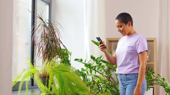 African American Woman with Smartphone at Home