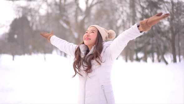 Young asian woman enjoy smile around snow and winter