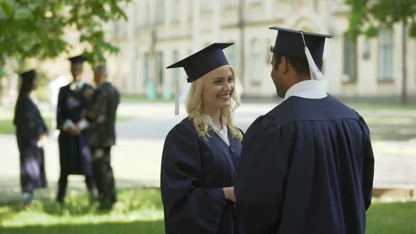 Graduate Students in Academic Outfit Hugging and Spinning, University Friendship