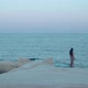 Woman Walks Along the Coastline on the Rocks - VideoHive Item for Sale