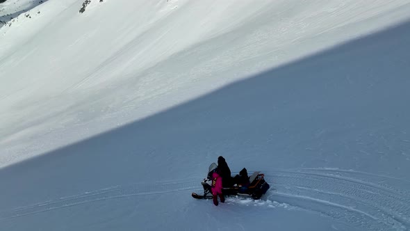 A snowboarder descends from the mountains aerial view 4 K