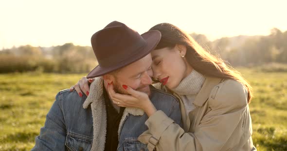 Young Man in a Hat with a Woman on a Picnic