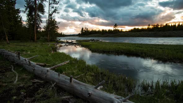 Time lapse after the sun has set over forest along river in Yellowstone