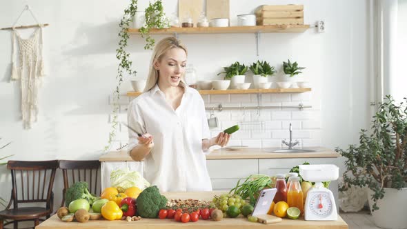 Woman Stands at a Table with a Lot of Vegan Food Ingredients She Talks About Proper Nutrition at