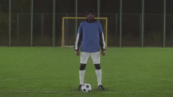 Soccer Player posing on Pitch