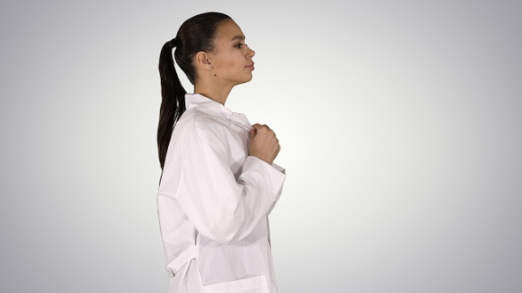 Young woman pharmacist in white gown coat uniform walking